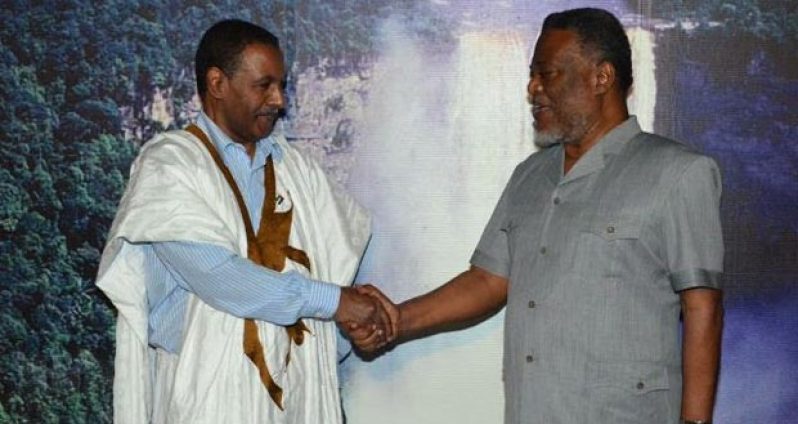 Prime Minister Samuel Hinds greets the newly appointed Sahrawi Ambassador to Guyana, His Excellency Lehebib Abderahaman Didi