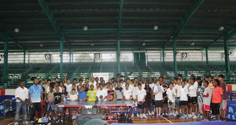 Digicel’s Gavin Hope, Minister of Sport Dr Frank Anthony, GTTA’s president Godfrey Munroe and National table tennis coach Linden Johnson (all in front row, seated) pose with all the school children at the closing ceremony of the Digicel-sponsored tournament.
