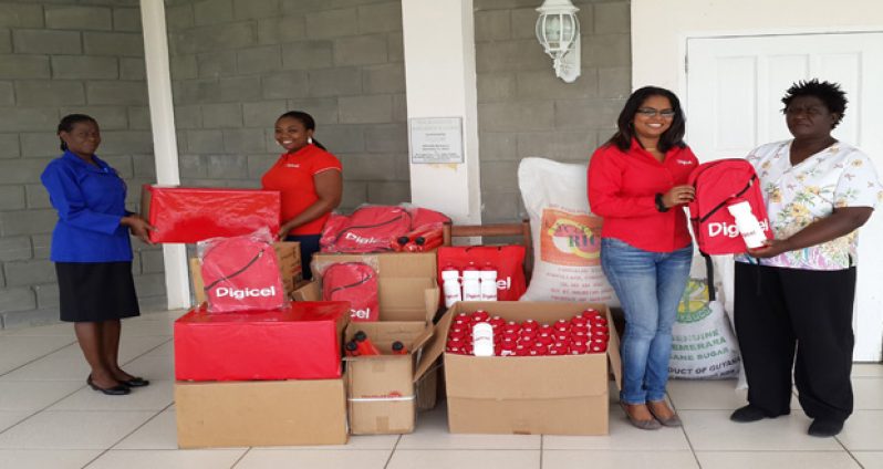 Digicel’s Senior Sponsorship Executive, Louanna Abrams, and Communications Manager Vidya Sanichara, hand over a quantity of school and other items to Pearline Cummings and Pam of the Mahaica Children’s Home