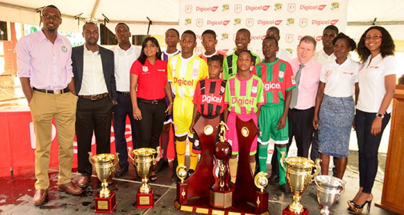 (L-R) Christopher Jones, Wayne Forde, Wismar representative Tevin Crawford, Nalini Veira, Covent Garden students with kits, CEO Kevin Kelly, Chase Academy captain Jeremy Garrett, Lovern Fraser and Jacqueline James (Adrian Narine photo)