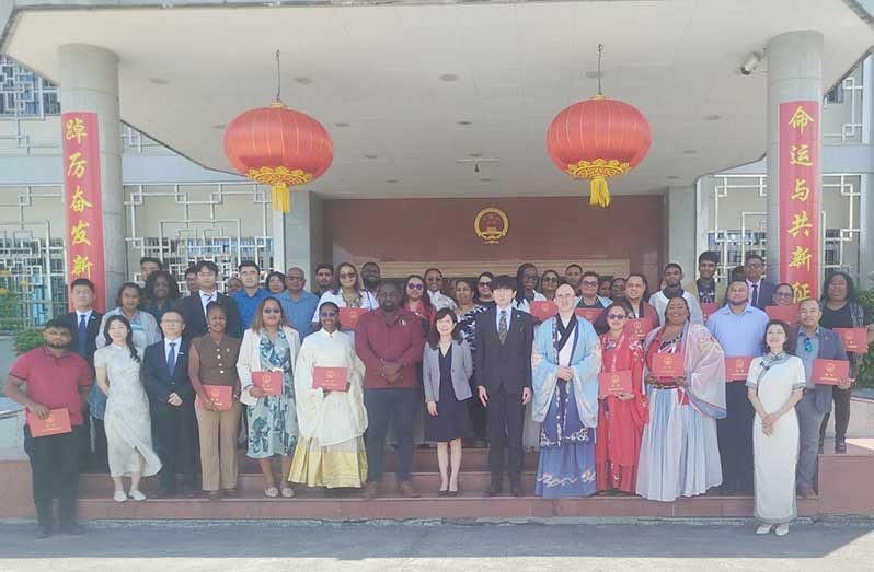 Chinese Ambassador Yang Yang (centre) next to Acting Permanent Secretary of the Ministry of Health, Dr. Cerdel McWatt, flanked by officials and participants of the programme