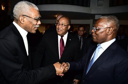 His Excellency, President David Granger is greeted by Provisional President of the Republic of Haiti, His Excellency, Jocelerme Privert at a dinner in honour of visiting Heads of Delegations as Haiti's Minister of Foreign Affairs, Mr. Pierrot Delienne looks on (MOTP photo)