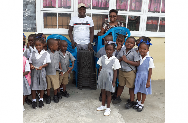 Chairman of the Nabaclis Youth and Community Development Co-op Foundation, Mr Keyon Morgan, with pupils and staff of the Nabaclis Nursery School