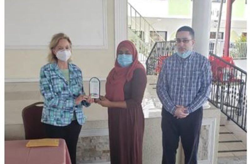US Ambassador, Sarah-Ann Lynch, receives a plaque of appreciation for her extraordinary service, commitment and contribution towards preserving democracy in Guyana