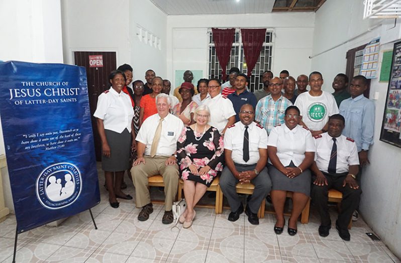 Elders William T. Bohne and his wife, Sister Sandra F. Bohne of the Church of Jesus Christ of Latter-day Saints with administrator of the Salvation Army's Drug Rehabilitation/Men's Social Service Programme, Major Ulrick Thibaud, other staff and inmates