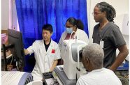 Dr. Huang Xiaobo (left) and local doctors Dr. Tamera Morrison (middle), Dr. Courtenay Taylor (right) in GPHC use OCT equipment to examine a patient