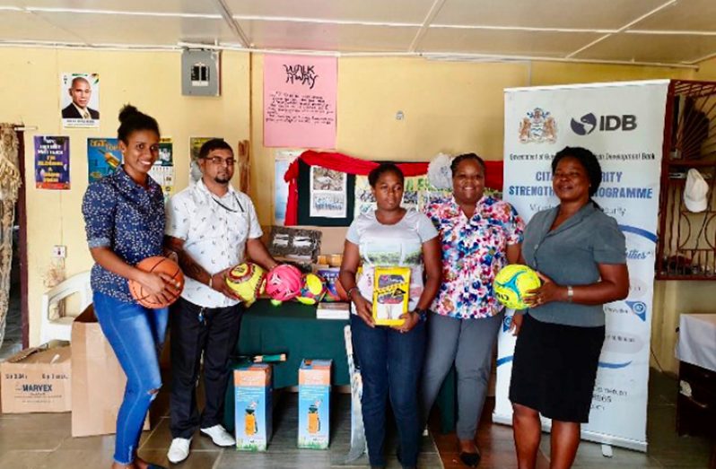 Angoy’s Avenue Adolescents Youth Space members receive the equipment from Community Action Specialist Lauren Fraser (second from right).