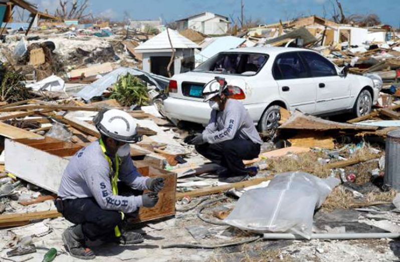 Personnel from the Florida Search & Rescue Task Force remove a body recovered in the destroyed Mudd neighborhood after Hurricane Dorian hit the Abaco Islands on Sept. 10, in Marsh Harbour, Bahamas