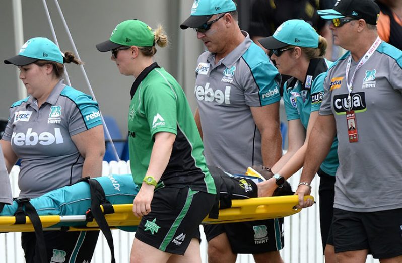 Deandra Dottin is stretchered away by team and WBBL medical personnel after a collision with Brisbane Heat teammate Laura Harris