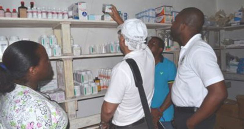 Minister of Public Health, Dr. George Norton inspecting a pharmacy during a recent visit to the Wakenaam Cottage Hospital (GINA photo)