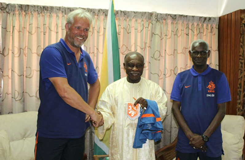 The Netherlands Royal Dutch Football Association (KNVB) Instructor Andre Simmelink shakes the hand of Minister of Foreign Affairs Carl Greenidge in the presence of Suriname’s Vice-Director at the Ministry of Sport and Youth Affairs Kenneth Jaliens.