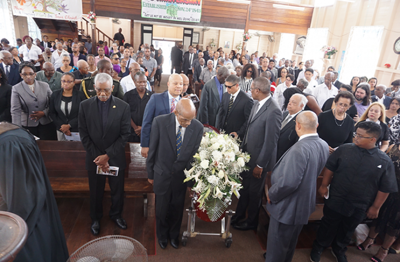 Pallbearers wheeling the earthly remains of the late Bryn Pollard to the altar for the commencement of the service