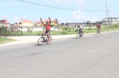 Hamzah Eastman (extreme left) races past Orville Hinds (second left) and others to win the 15th Annual Diamond Mineral Water 50-Mile cycle road race yesterday (Sonell Nelson photo).