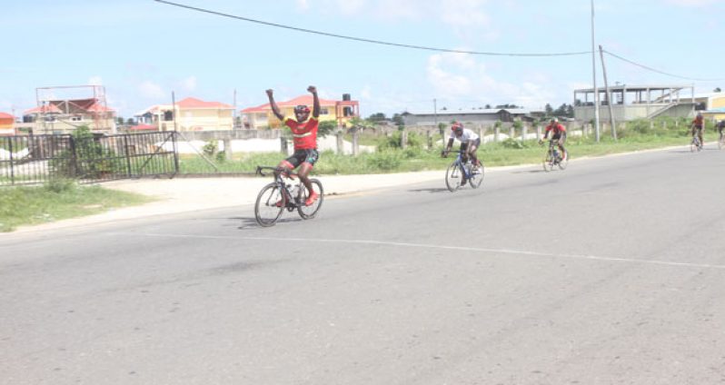 Hamzah Eastman (extreme left) races past Orville Hinds (second left) and others to win the 15th Annual Diamond Mineral Water 50-Mile cycle road race yesterday (Sonell Nelson photo).