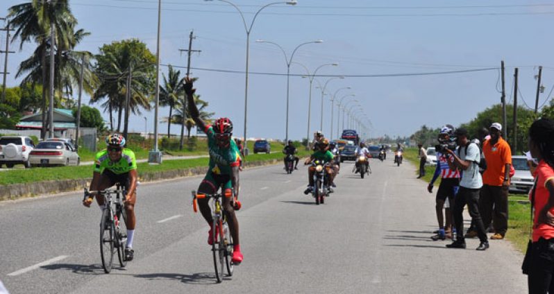 District 11 Hamza Eastman raises his hand in triumph after outsprinting Paul De Nobrega to take the 40km.