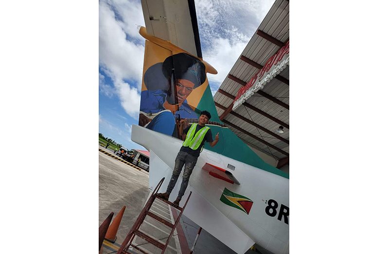 : In this photograph which was among several posted on Eddy Grant’s Facebook page, a smiling Ransford Simon stands proudly next to the finished portrait (Eddy Grant photo)