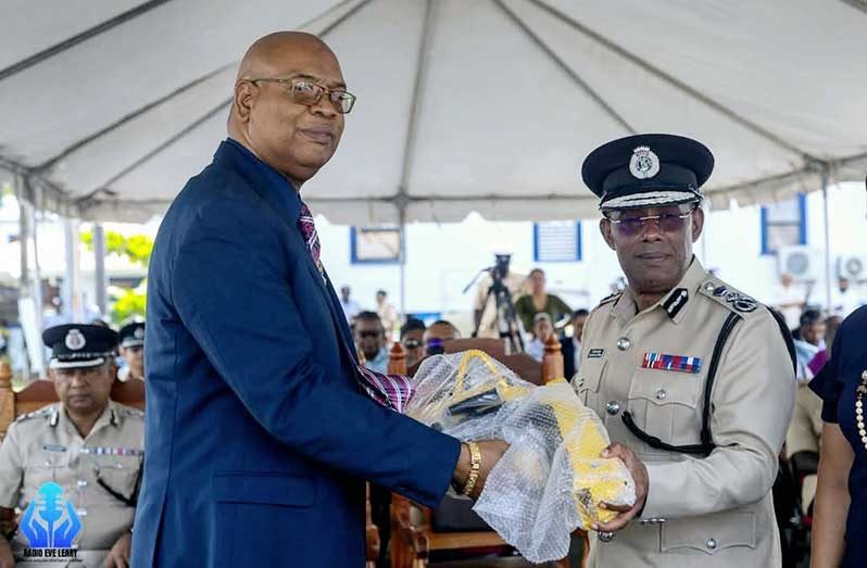 Minister of Public Works Bishop Juan Edghill presents Commissioner of Police Clifton Hicken with one of the new traffic management equipment