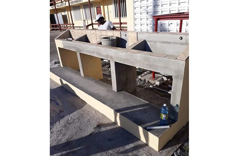 A contractor working on one of the many water troughs being constructed at a secondary school in Region Five (Ministry of Education photo)