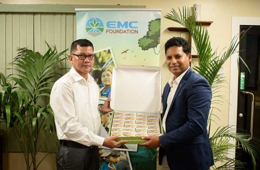 DCEO-Amerindian and Hinterland Education Development, Marti DeSouza, receives the donation from EMC Foundation founder and director, Shyam Nokta (EMC Foundation photo)