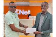 ENet’s Business Head, Devon London, (right), makes his company’s presentation to Slingerz Family Entertainment representative, Aswell Mohabir for this year’s Vergenoegen Village Day (Enet photo)