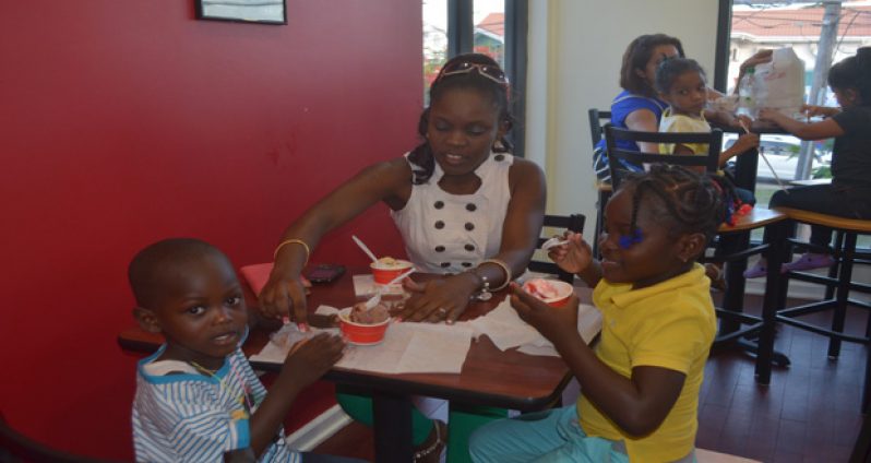 Children enjoying the taste of Bruster’s ice cream yesterday