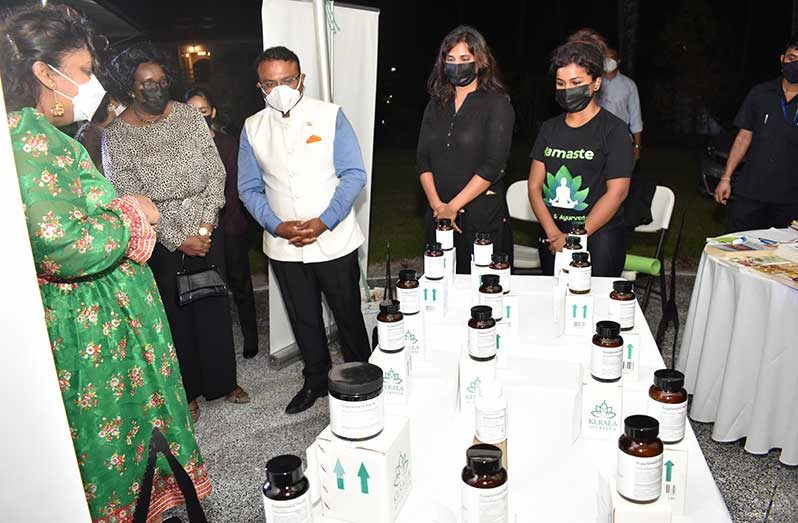 Indian High Commissioner to Guyana, Dr. K.J. Srinivasa; Education Minister, Priya Manickchand, and others examine the ayurvedic products on display during ITEC Day on Wednesday (Carl Croker photo)