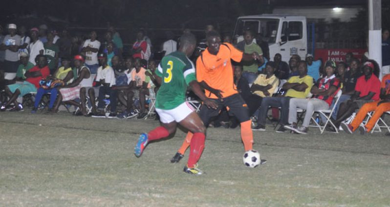 Alpha United’s Gregory ‘Jackie Chan’ Richardson being kept in check by Western Tigers in their match-up.