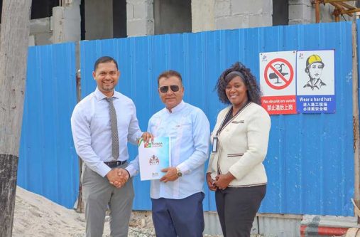 Chief Investment Officer and Agency Head of the Guyana Office for Investment, Peter Ramsaroop, hands over the Investment Agreement