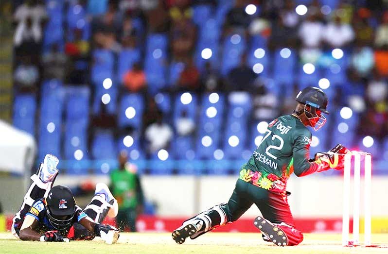 Kofi James (R) of Antigua and Barbuda Falcons makes his ground as Andre Fletcher of St Kitts and Nevis Patriots attempts to run him out during the Republic Bank Caribbean Premier League match between Antigua & Barbuda Falcons and St Kitts & Nevis Patriots at Sir Vivian Richards Cricket Ground on August 29, 2024 in Antigua, Antigua and Barbuda. (Photo by Ashley Allen - CPL T20/CPL T20 via Getty Images)