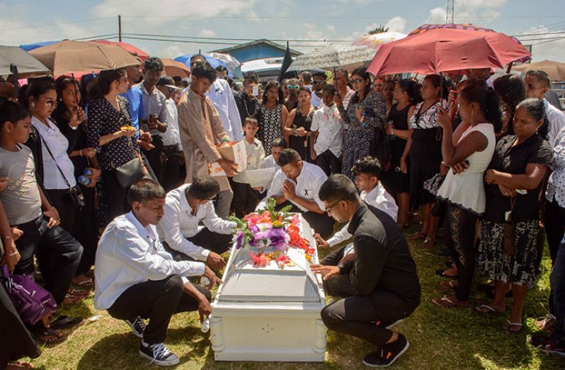 Family members prepare the body for cremation