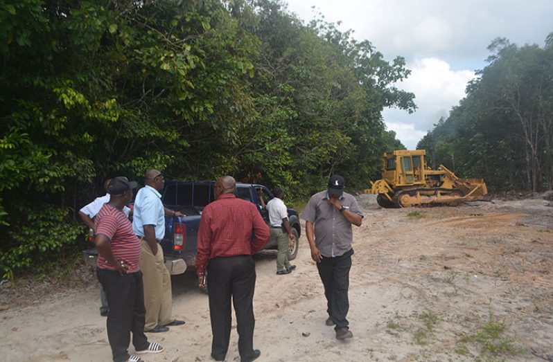 Regional officials inspecting the farm-to-market road project at Millie’s Hide Out, Linden