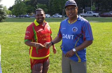 DEBUTANT Farook Hussain (left) receives a token of appreciation from Andrew Persaud for his brilliant knock.