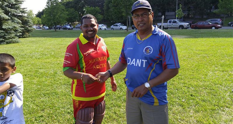 DEBUTANT Farook Hussain (left) receives a token of appreciation from Andrew Persaud for his brilliant knock.