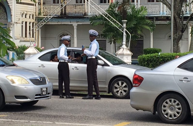 Two Guyana Police Force Traffic Cops on duty doing a routine check.