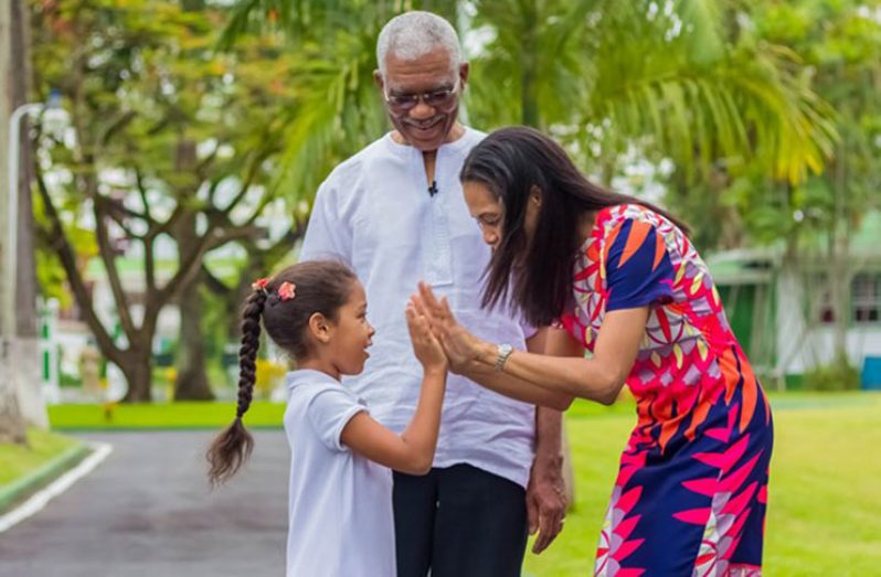 President David Granger admires his daughter, Mrs. Han Granger- Gaskin and granddaughter, Faraa Gaskin, as they play a game at State House, Georgetown (Ministry of the Presidency photo)