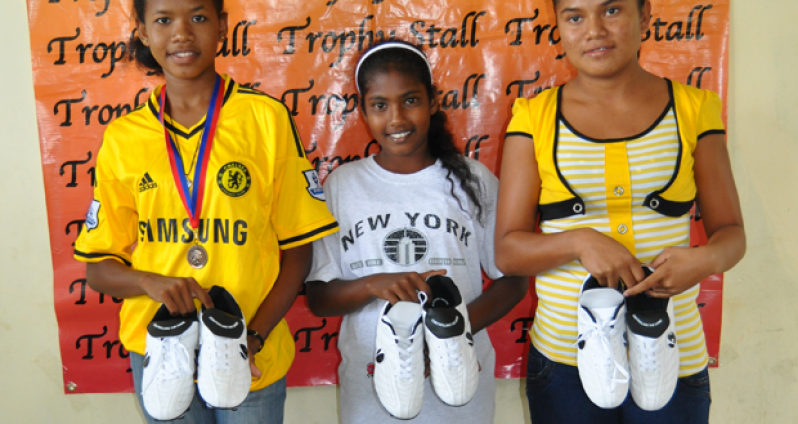 Recipients of the Mitseden soccer boots from right: Krista De Silva, Nikita Amardeo and Diana Angoy.