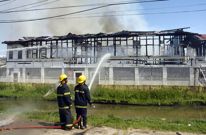 Firefighters were busy trying to put out the blaze (Adrian Narine photo)