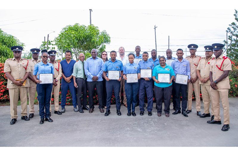 Minister of Home Affairs, Robeson Benn (seventh from left), senior fire officers and the new Advanced Emergency Medical Technicians following the graduation exercise. Also pictured in this Guyana Fire Service photo is Adviser to the Ministry of Health, Dr Leslie Ramsammy (sixth from left)