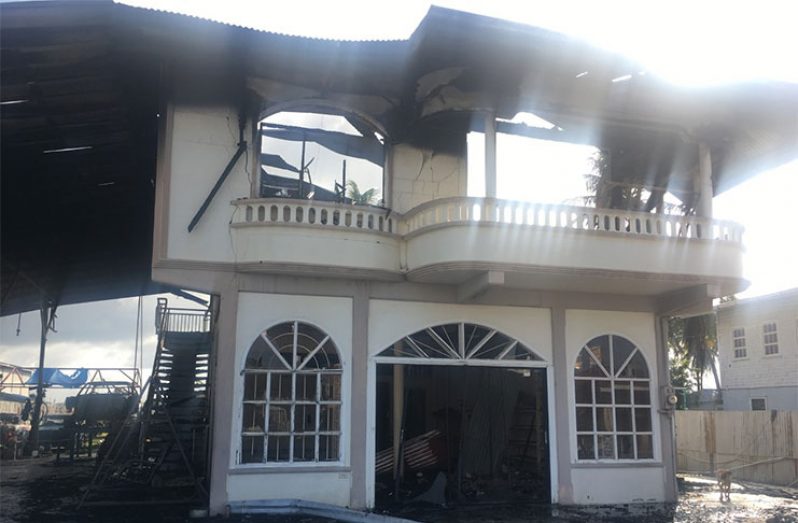What’s left of the building which housed the dwelling home of Persaud and his family and his business