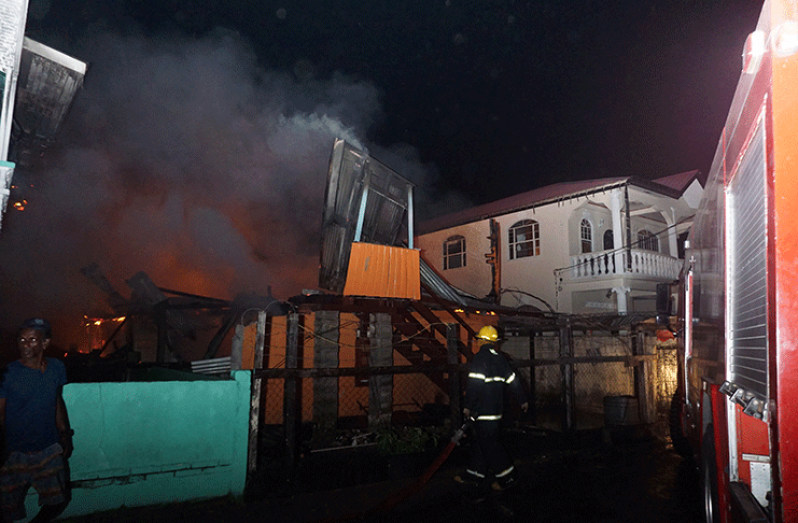 Firefighters battle to out the last of the flames that destroyed the Lot 28 School Street Peter’s Hall property that left six homeless (Elvin Croker photo)