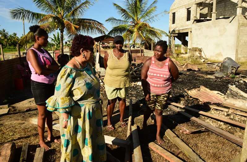 Minister of Social Protection, Amna Ally in conversation with the fire victims at the site (Adrian Narine photo)