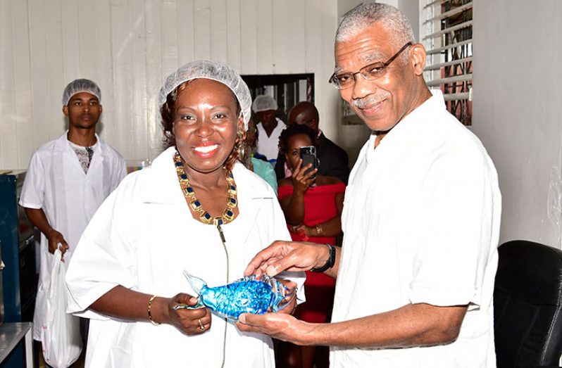 Chief Executive Officer of Global Seafood Distributors, Mrs. Allison Butters-Grant presented President David Granger with a crystal fish paperweight, as a token of appreciation