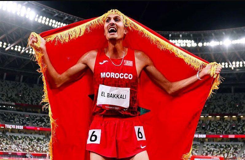Moroccan El Bakkali wrapped his country's flag around himself to celebrate his victory.
