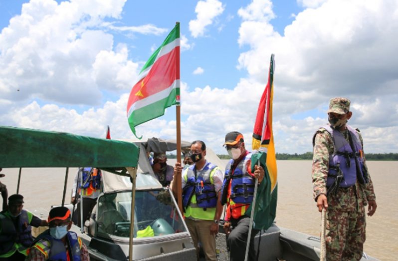 Public Works Minister, Bishop Juan Edghill, and the Surinamese delegation sail up the Corentyne River to plant the flags at Long Island