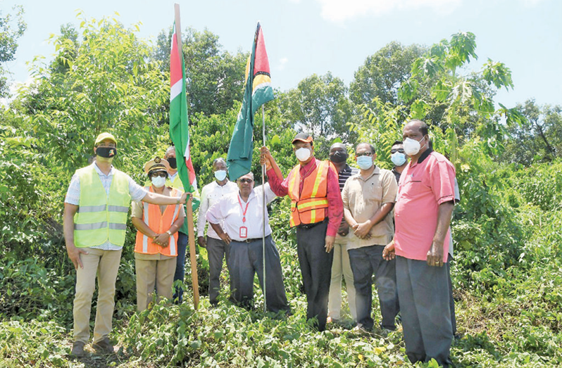 Flashback: Public Works Minister, Bishop Juan Edghill, accompanied by a Surinamese trekked through the bushes to plant flags at the bridge’s intended location