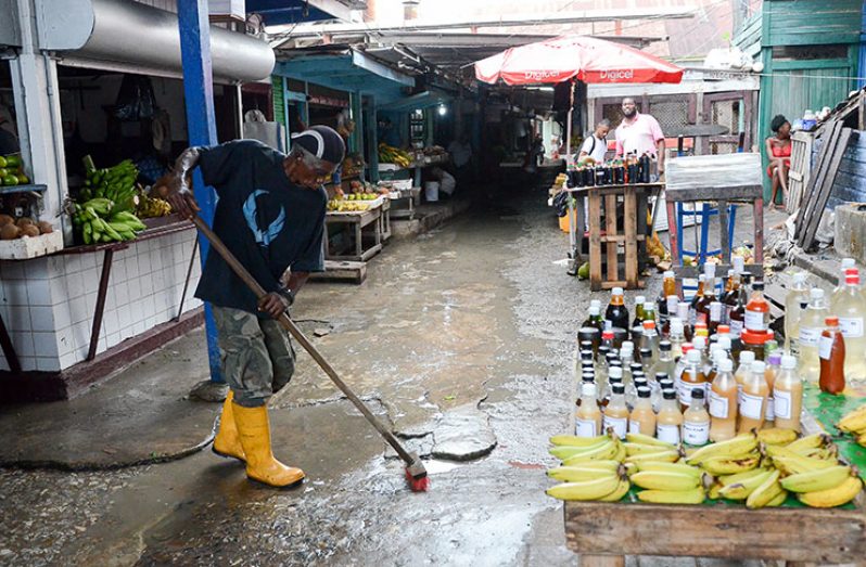 A vendor cleaning up after the flood