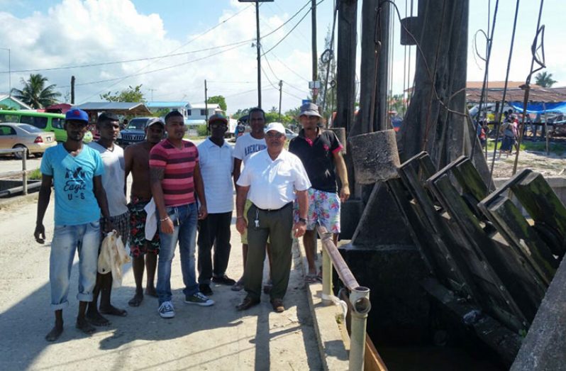 REO of Region Three, Denis Jaikaran (second left) share a light moment with Hubu farmers after the flood was averted (RDC photo)