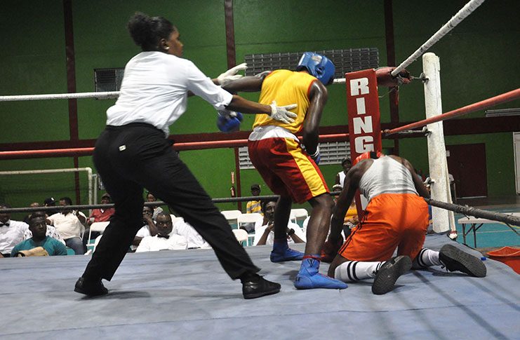 GDF’s Troy Miggins floors Republican Gym boxer, Deon Samuels as referee Ramona Agard rushes in to stop the fight in the final round(Sean Devers photo)