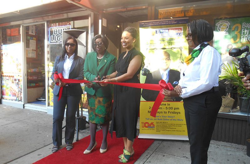 Guyana’s Consul General to New York, Barbara Atherly, cuts the ribbon with Fly Jamaica's Marketing Director, Kayla Reece, to open the company's Brooklyn office
