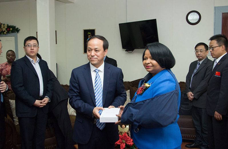 Minister of Public Health, Ms Volda Lawrence (right) receives a gift from Mr Huang Yuanzheng, Vice-Mayor of Lianyungang
